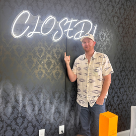 Alexander Dimaggio standing proud under the CLOSED sign